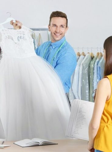 man working with customer in dry cleaning salon